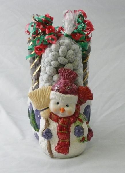 Snowman candy dish - This cute snowman has a candy dish behind him filled with over 1 pound of chocolate covered caramel corn and  pound of snowy praline peanuts.
